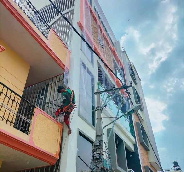 a man installing apartment duct nets in bengaluru