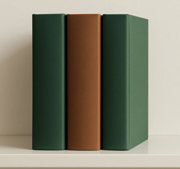 A row of three academic textbooks standing on a clean shelf. The covers use a palette of Forest Green and Wood Brown with elegant serif typography. Clean, bright North American interior lighting.