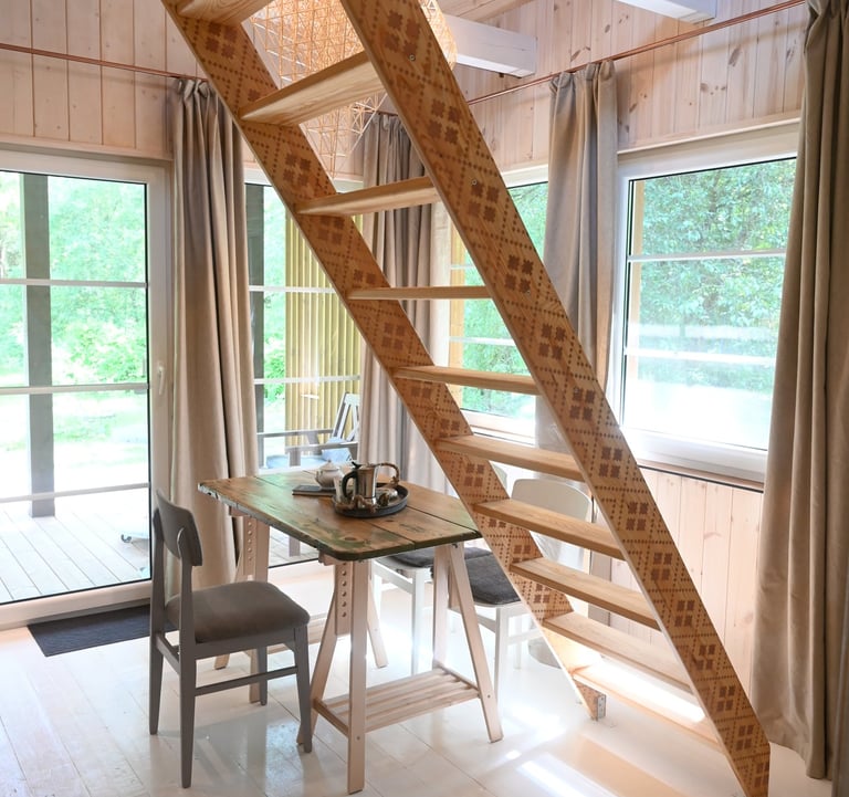 a wooden staircase leading to a lofted room