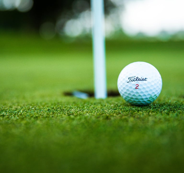 a golf ball sitting on the ground near a golf ball
