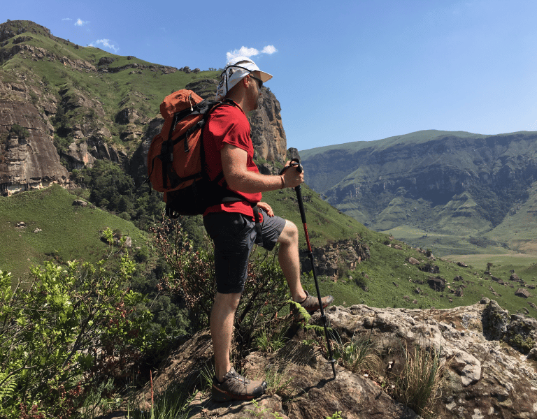 a man with a backpack on a mountain