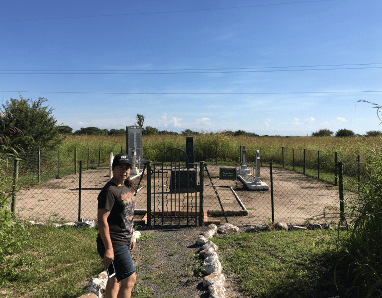 a woman in a hat at a Boer War grave site