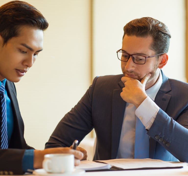 Two men engaged in interview coaching, discussing strategies and techniques to enhance job interview performance.