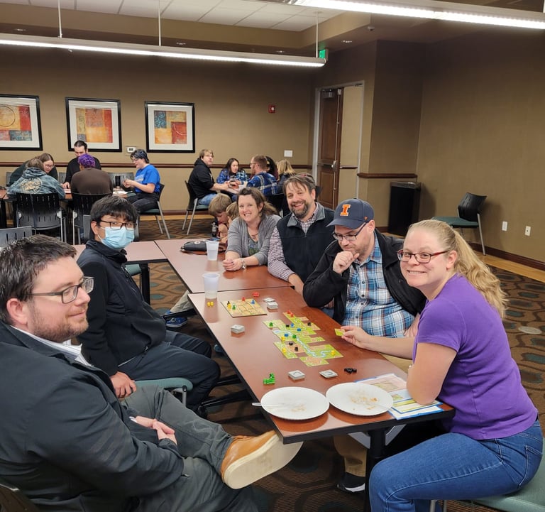 Dr. Hooton, history faculty, and students playing board games.