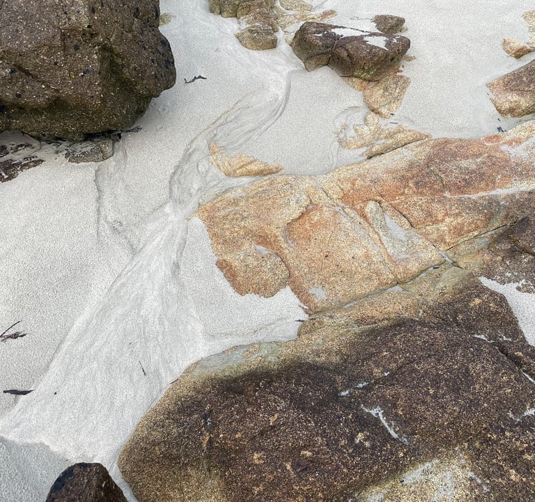 plage de sable avec quelques rochers