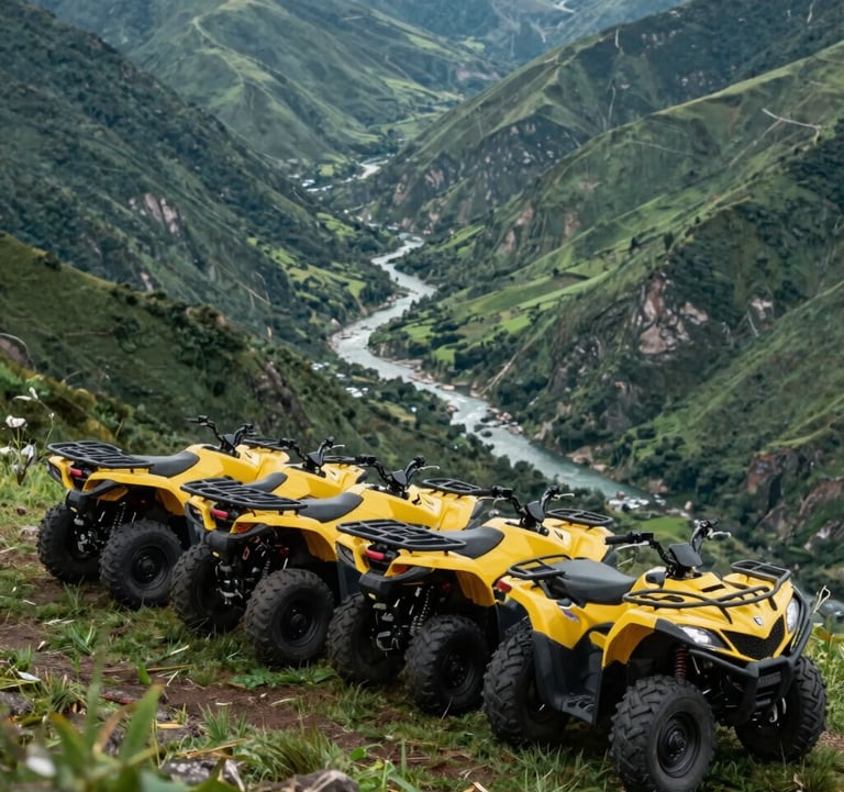 A line of four modern yellow quad bikes parked on a grassy mountain ridge overlooking a deep green valley with a river snaking through it.