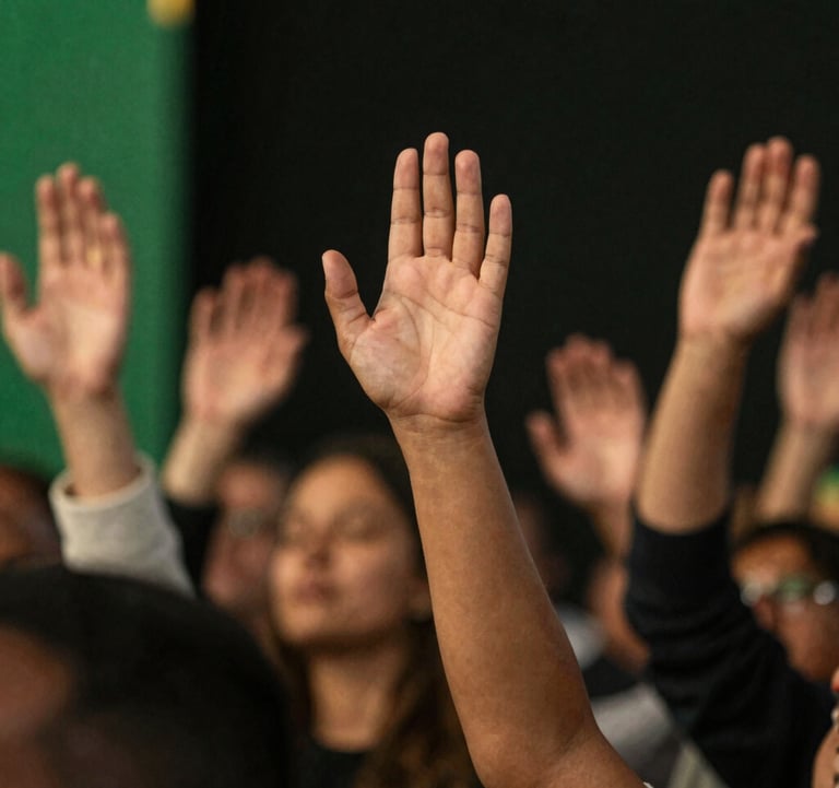 Close up of diverse hands raised in worship, warm stage lighting with gold accents (#D8B863) against a dark premium backdrop. High-end photography style.