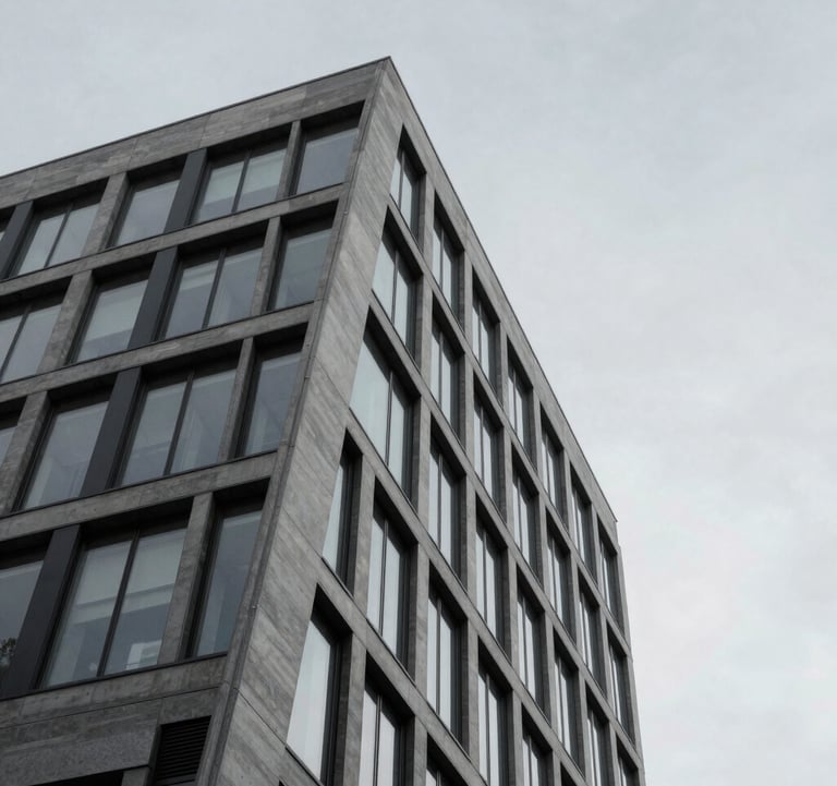 A minimalist architectural detail of a luxury financial building in Western Europe. Sharp geometric lines against a pale grey sky. The composition is clean and understated, emphasizing trustworthiness and modern elegance.