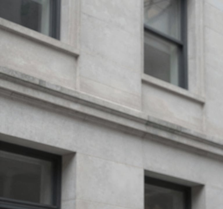 Close-up architectural detail of a modern limestone facade in Streeterville, Chicago. The lighting is crisp, highlighting the clean lines and high-quality materials. Palette includes #EFEFEF and #1A202C shadows.