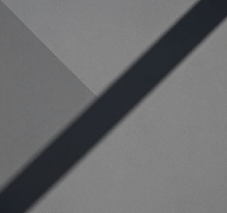 An abstract, editorial photograph of geometric shadows cast upon a matte gray surface. Professional, calm, and architectural, evoking a sense of deep cognitive engagement.
