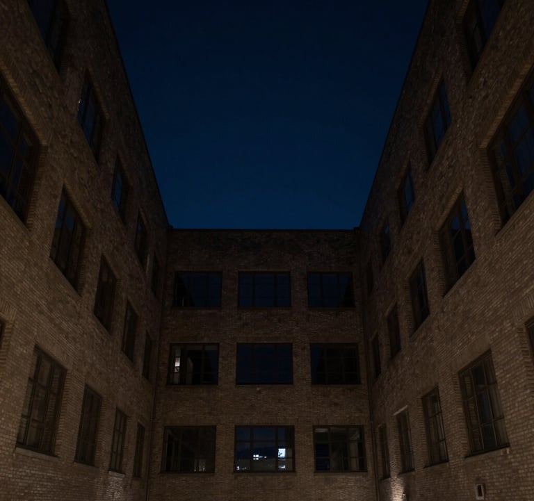 An architectural photograph looking up a dark, narrow courtyard towards a square of night sky in an international business capital. Minimalist, quiet, and authoritative.