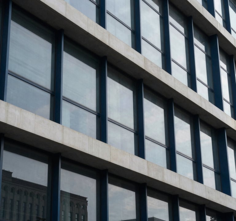 A sophisticated photograph of an architectural detail in a modern steel and glass building, with tones of dark navy blue and off-white, reflecting institutional stability.