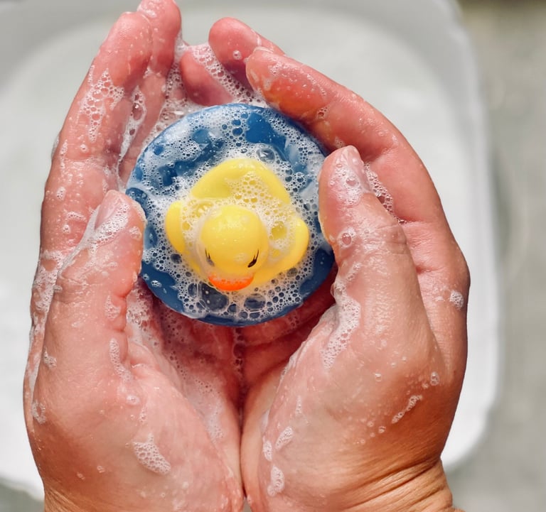 a person holding a custom made soap as a rubber duck in their hands