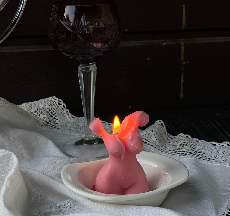 a hand made pink candle in a form of  a human body