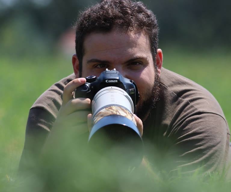 a man taking photo with telephoto lens