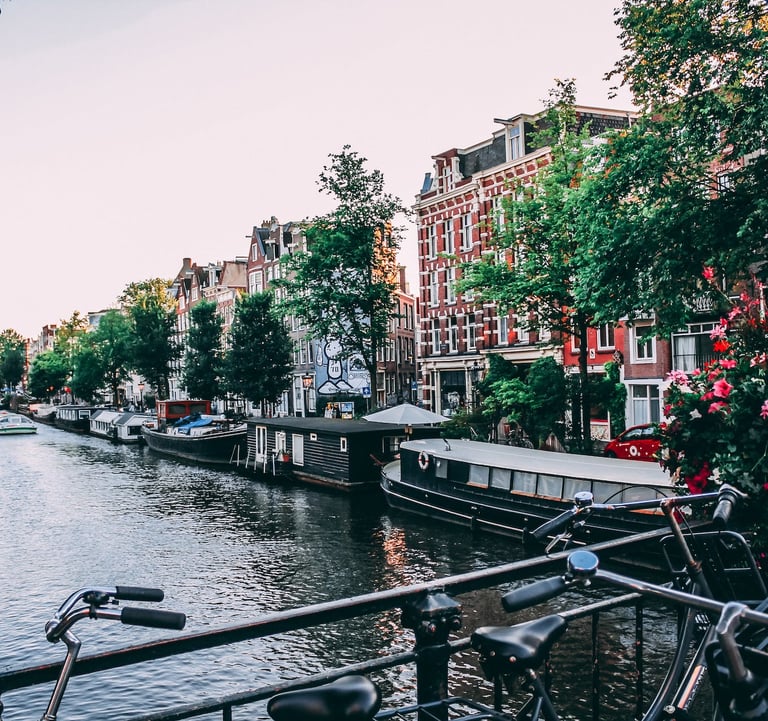 bicycles parked on a bridge over a river in Amsterdam