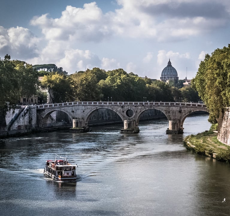 a boat on the water with a bridge in the background in Rome