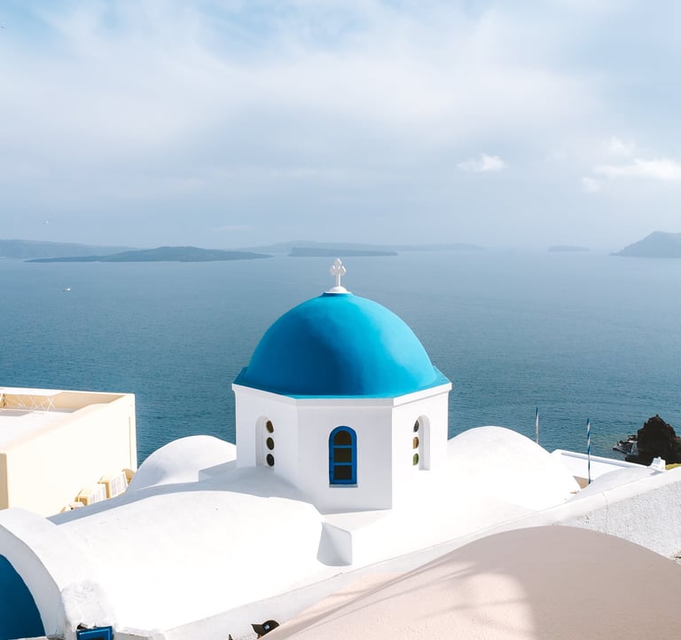 a blue dome shaped building with a blue dome shaped building in Greece