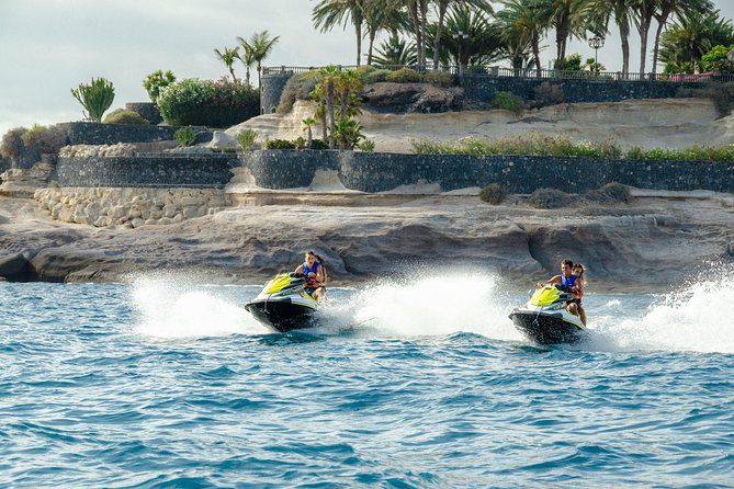 three people are riding on jet skis in the water