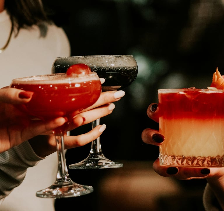 Group of women clinking drinks symbolizing Single Girl’s Guide lifestyle series
