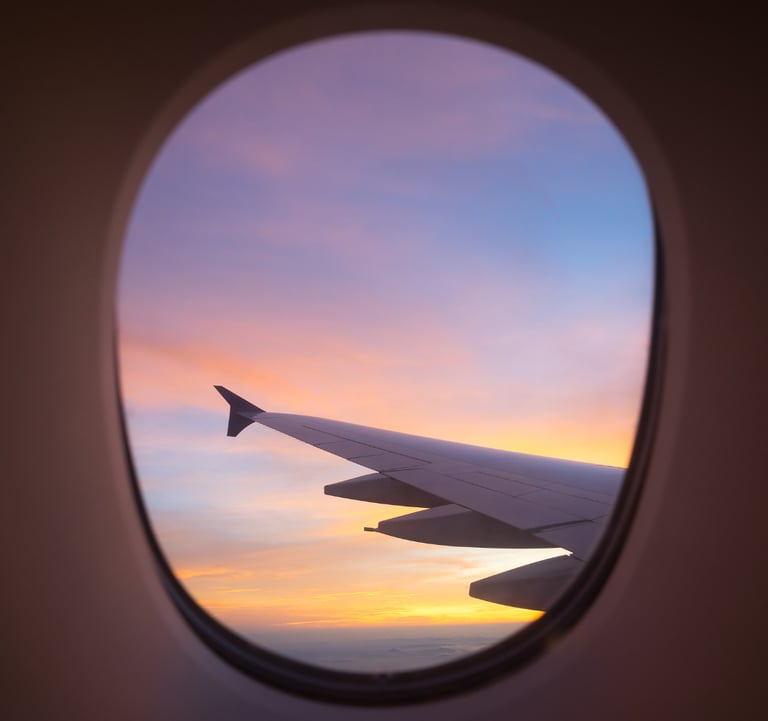 Airplane window view symbolizing Sarah Melland’s travel books and guides