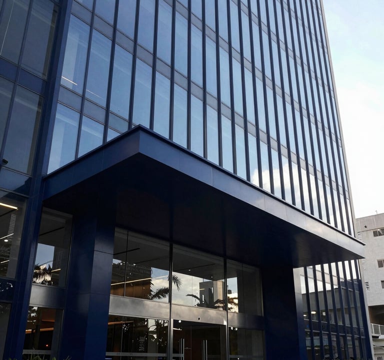Modern architectural detail of a premium building entrance in a South American / Brazilian capital. High-contrast photography with sharp lines and glass reflections, using a color palette of Deep Navy Blue and Soft Steel Blue to convey reliability and solidez.
