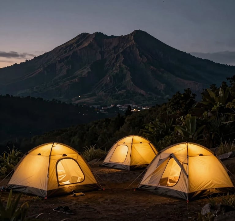 A cozy, premium camping setup on the Rinjani crater rim at dusk. Warm yellow light glows from sturdy geodesic tents. In the background, the silhouette of the volcanic peak is outlined against a deep twilight sky of charcoal and dark forest green.