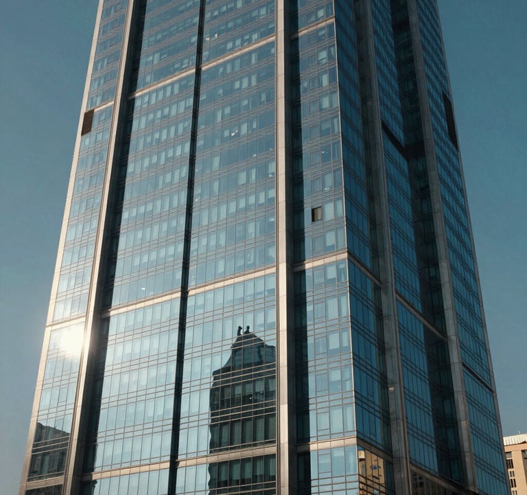 Cinematic exterior shot of a modern glass skyscraper facade reflecting the clear blue sky of Egypt. Sharp lines, architectural detail, and a sense of premium quality and technological advancement.