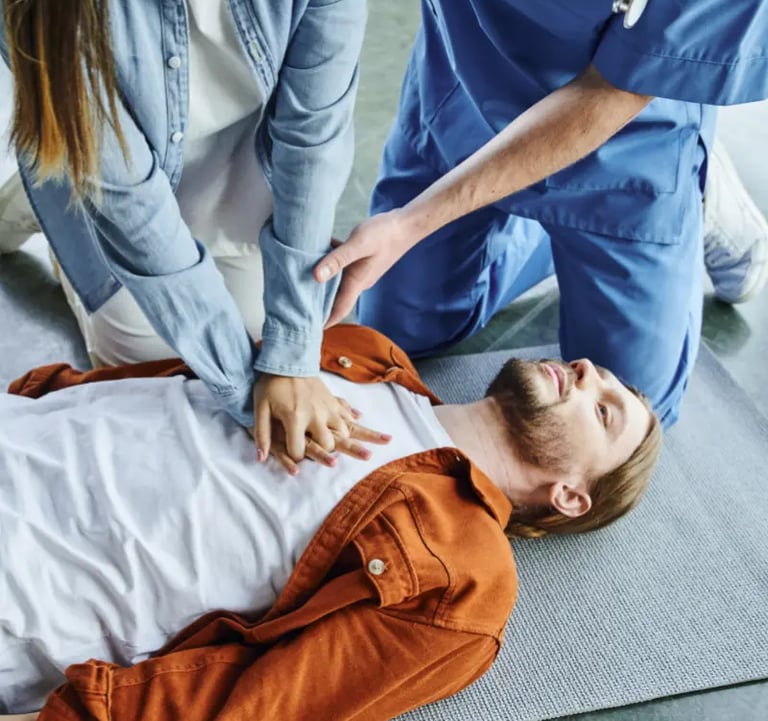 Training CPR on a man laying on the ground