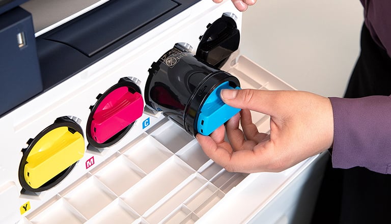 Woman loading printer toner