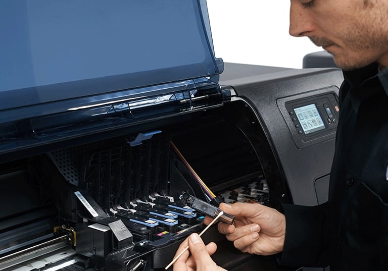 Man repairing an HP DesignJet Printer