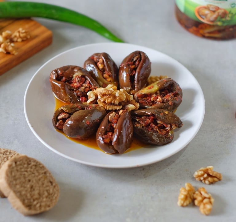 a plate of chocolate covered stuffed peppers and nuts