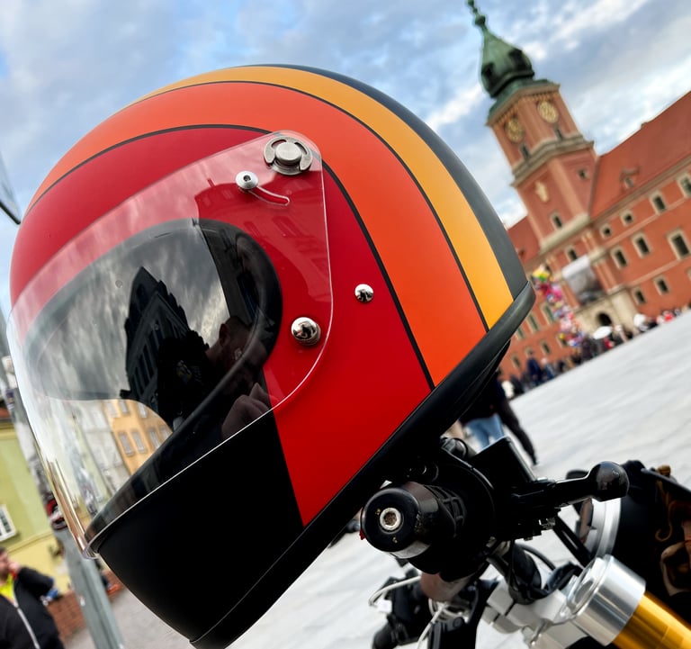Kask motocyklowy w stylu brat DMD Rocket Fuoco na tle starówki w Warszawie