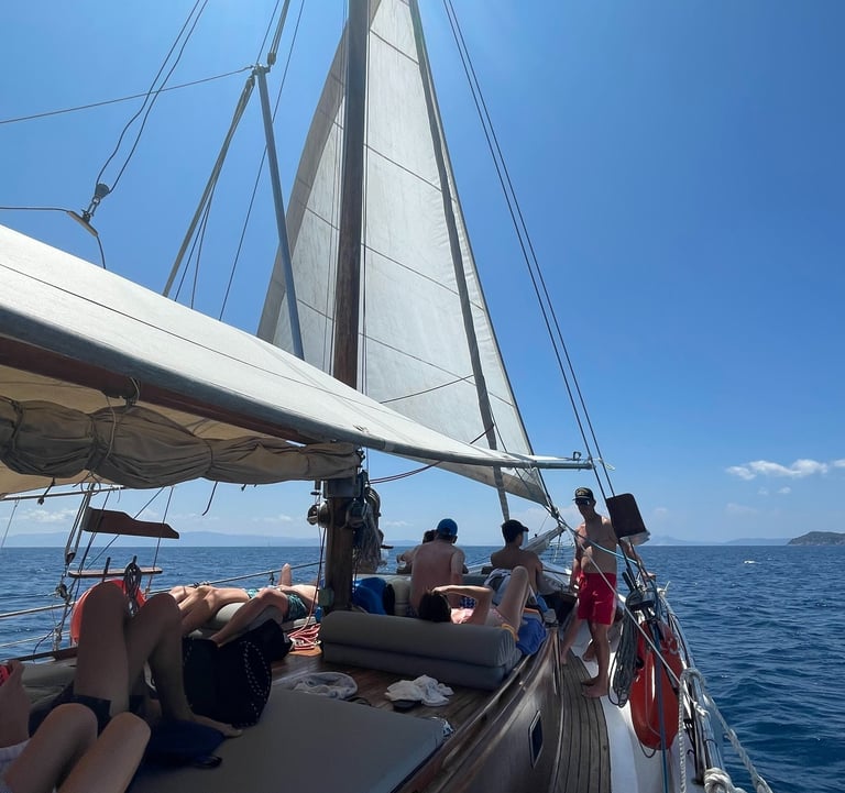 a group of people on a boat daily cruise in skiathos