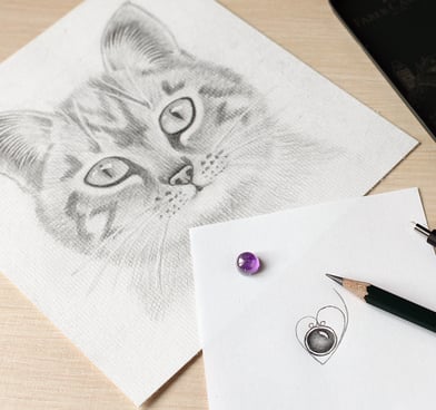 Hand drawn cat and sketching the design of a silver cat jewellery