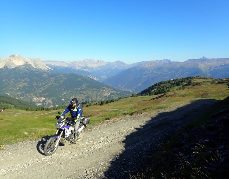 a person on a dirt bike on a dirt road