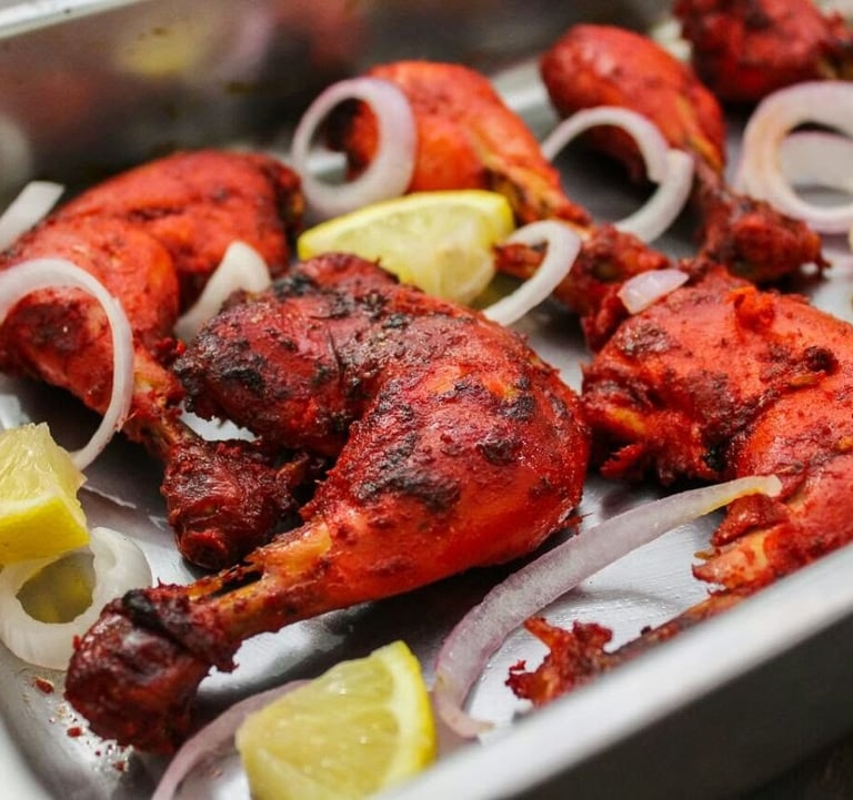 a tray of chicken wings with onions and onions