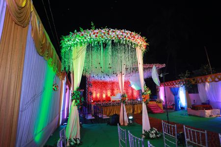 a decorated stage with a canopy tent and stage set up for a wedding
