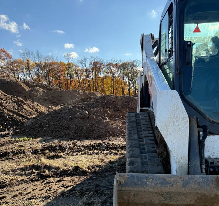 skid-steer-with-dirt-pile