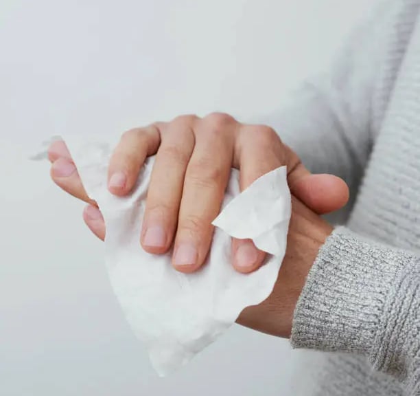 Cleaning a hand with a wet wipe