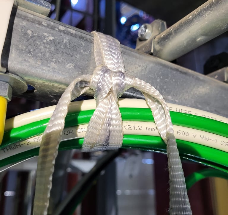 Woodlands Ziptie Knot securing a bundle of heavy electrical conductors to Unistrut