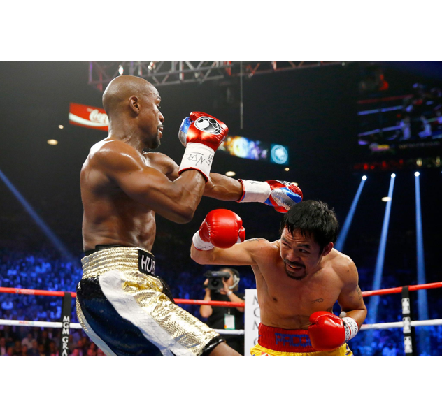 Professional boxers Floyd Mayweather and Manny Pacquiao competing in a championship boxing match ring.