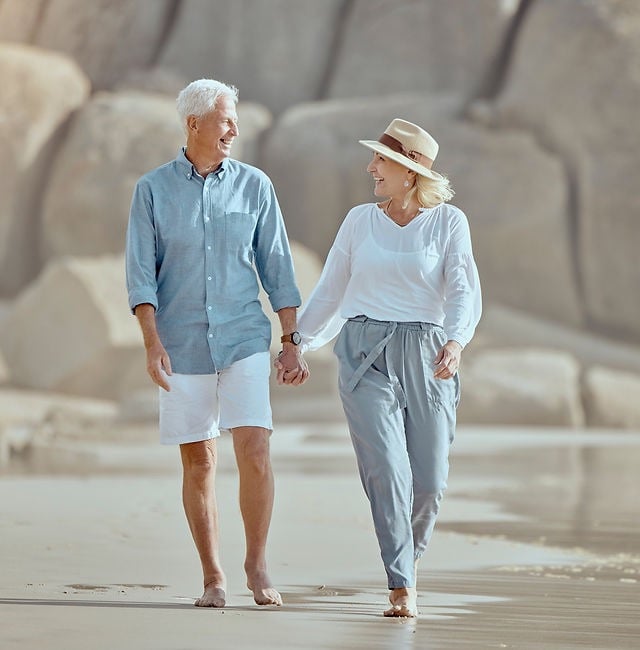 a couple walking on a beach