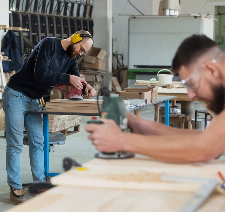 a man and woman working in a workshop
