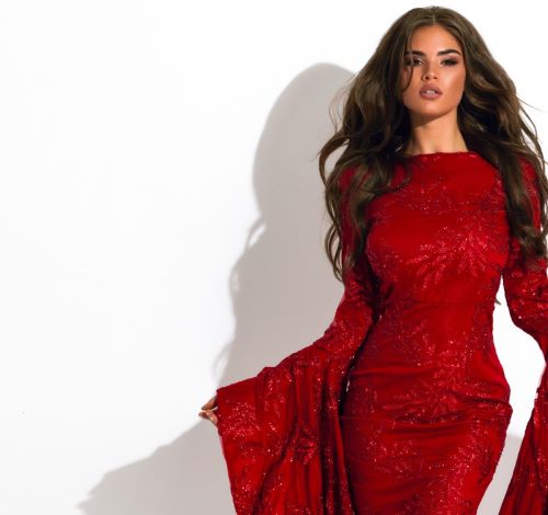 a woman in a red dress with a long sleeved dress