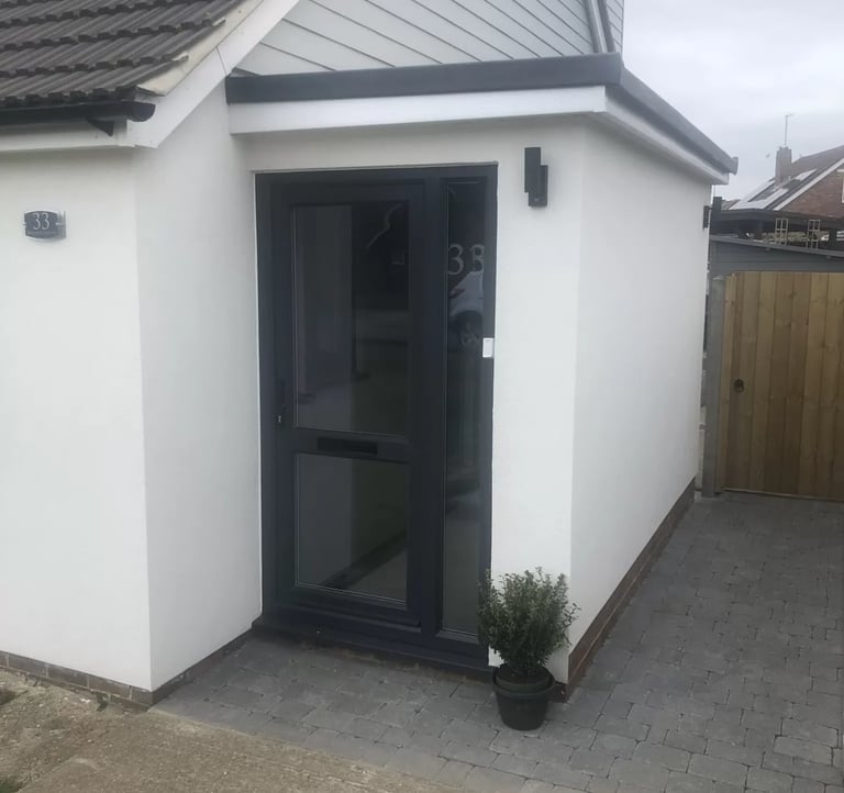 Completed rear house extension with modern entrance built by builders in Brighton.