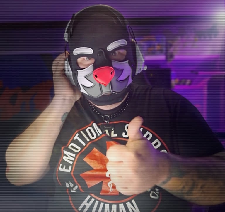 Man in a pup mask and headphones.