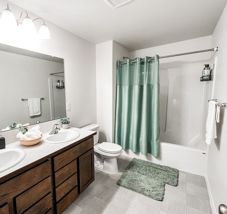 a bathroom with a green shower curtain and a green shower curtain