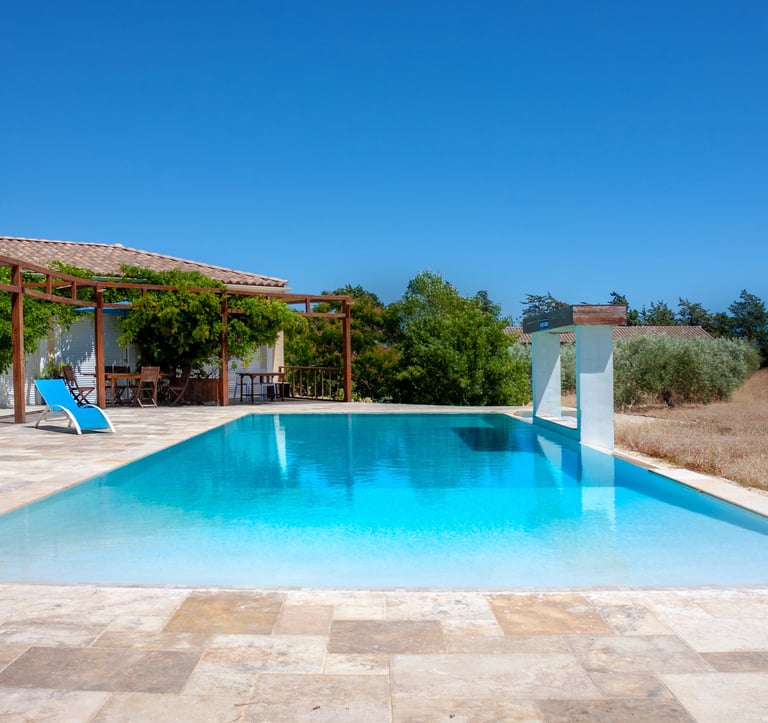 Swimming pool with beach chairs, wide view and waterfall cascade built-in at Domaine Des Lucques