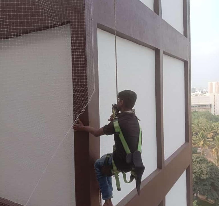 a technician installing duct nets for pigeons in bengaluru